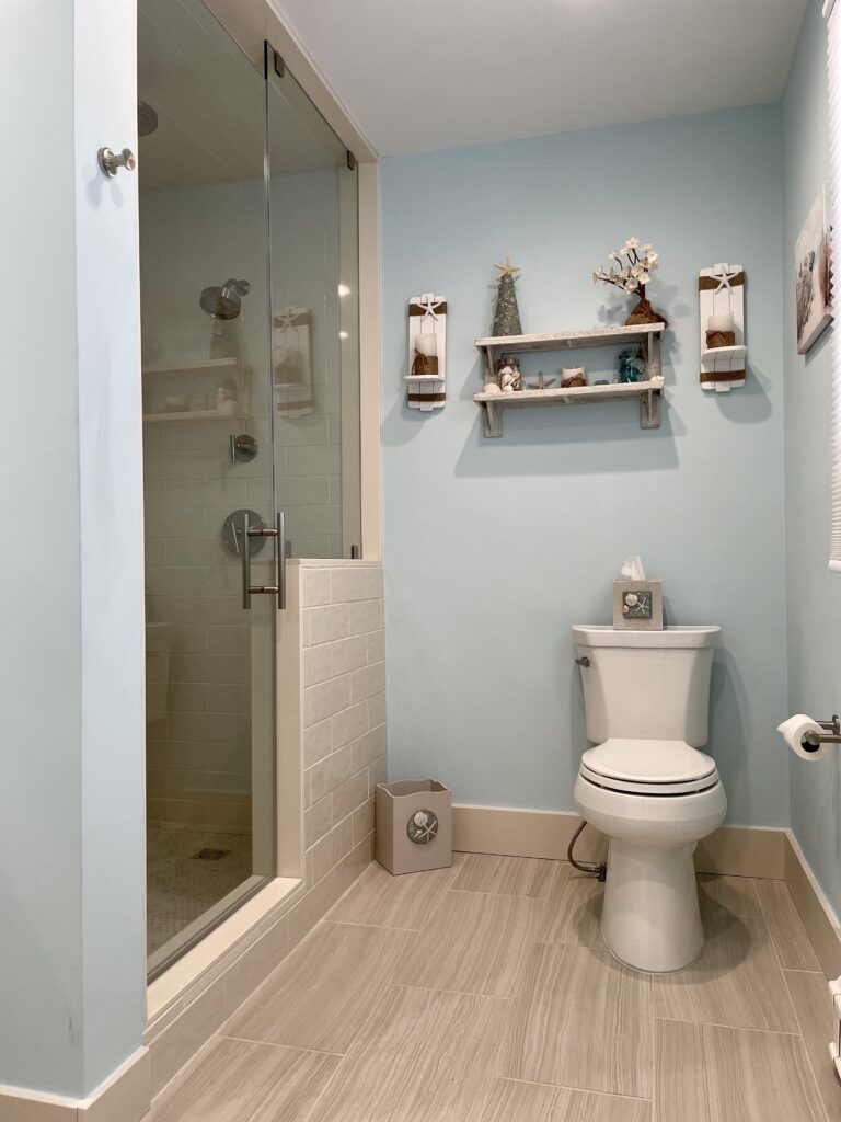 Modern bathroom with glass shower and toilet.