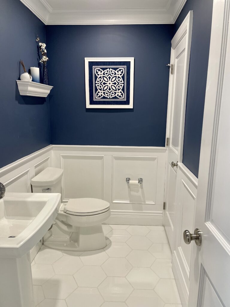 Clean bathroom with blue walls and white fixtures.