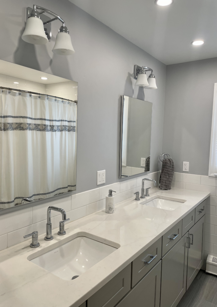 Modern bathroom with dual sinks and a large mirror.